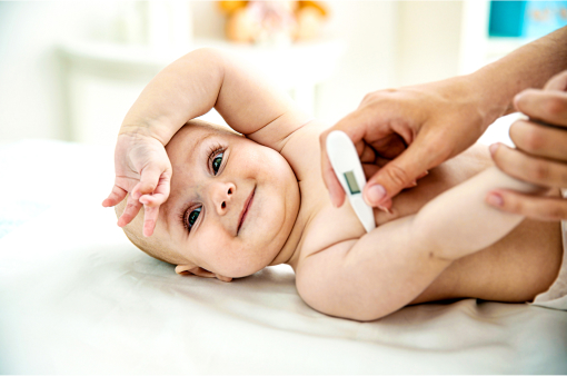 Playful baby gets temperature measured electronically