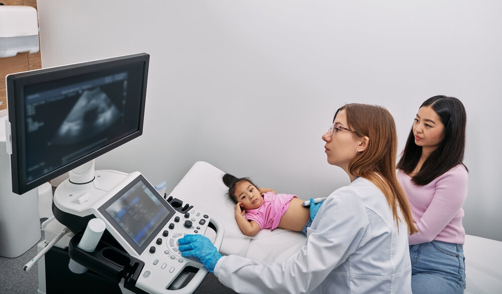 ultrasound procedure of internal organs with sonographer at medical clinic. Pediatric abdominal ultrasound
