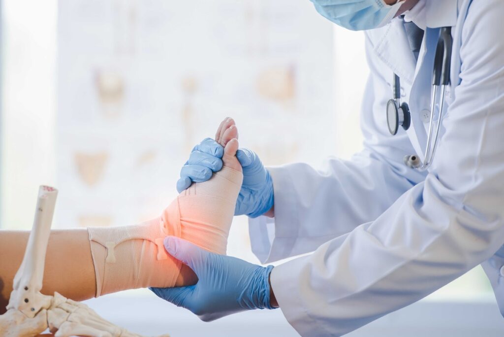 Male orthopedic doctor examining the cause of ankle bone degeneration