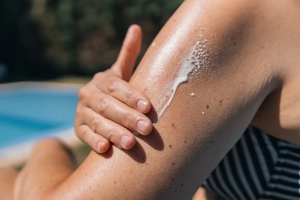 Close-up of a woman's hand applying sunscreen