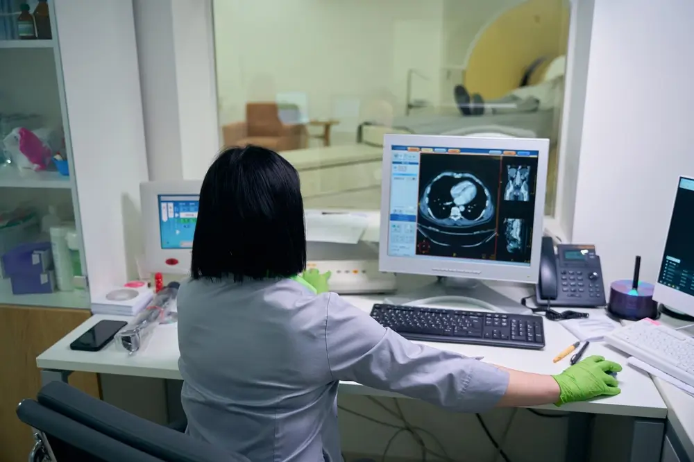 Lady in doctor coat looking at MRI results
