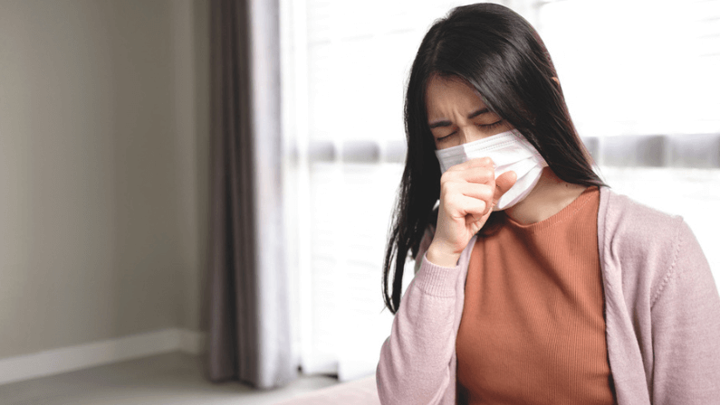 Young Asian women use mask to cover their mouth and nose during colds, coughing and sneezing to prevent the virus from spreading. Concept of health care and medicine