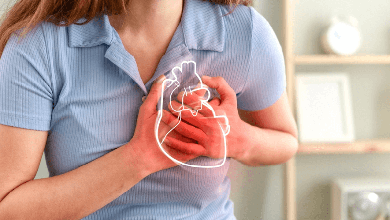 Young woman pressing on chest with painful expression.