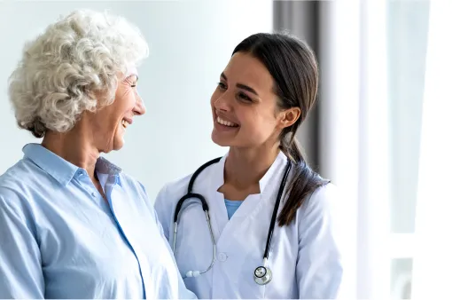 Smiling young female general practitioner sharing good health news with senior woman.