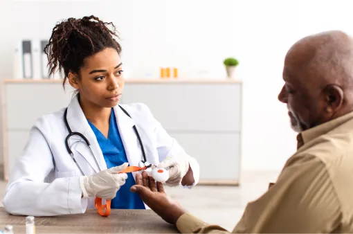 Female doctor getting blood sample for test from a male patient.