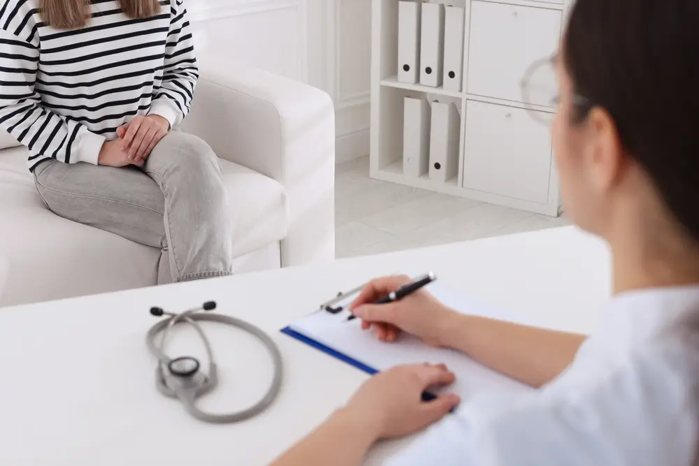 Young woman having appointment with STD specialist in clinic, closeup
