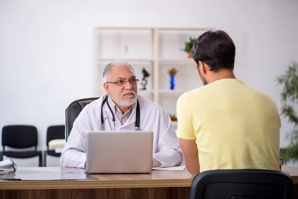 Young male patient visiting old male doctor